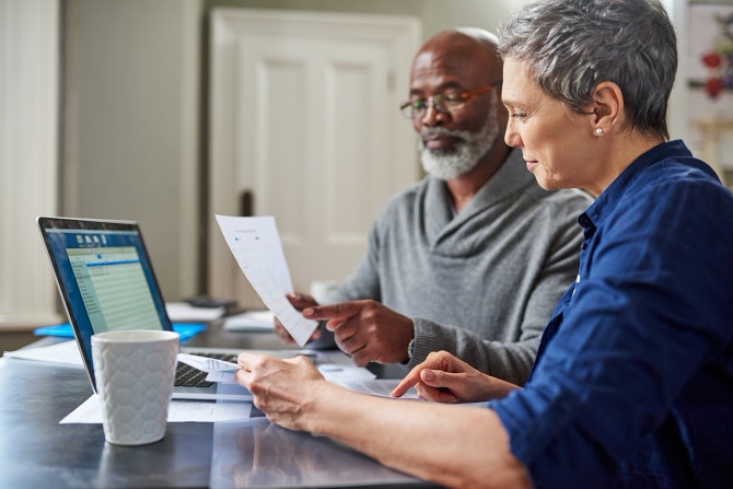 Older couple looking over their finances for retirement